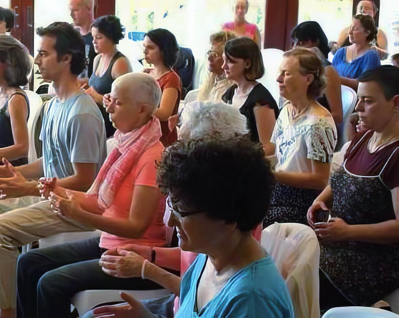 Participants seated in a peaceful, sunlit room, practicing Lachi