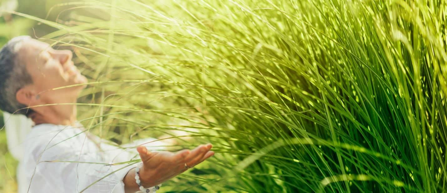 A woman standing in a field of tall grass.