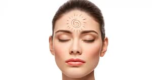 A woman with closed eyes radiates calm and focus, with a spiral symbol surrounded by rays drawn on her forehead, representing intuitive insight and serving from an awakened consciousness. The minimalist white background emphasizes her serene expression.