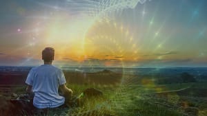 A person meditating on a grassy hill at sunset, overlooking a vast landscape, with glowing energy patterns and sacred geometry swirling in the sky, symbolizing deep spiritual awakening, mindfulness, and connection to the universe.