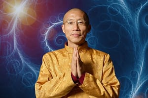 Master Mingtong Gu in a golden traditional outfit, with hands in a prayerful gesture, set against a vibrant background of swirling blue and red energy patterns, symbolizing inner peace, spiritual connection, and healing energy.
