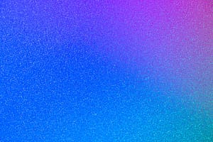 Sparkling glitter texture with a vibrant gradient of blue, purple, and teal hues.