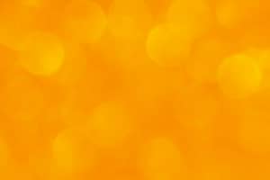 Bright golden-orange bokeh background with soft, glowing light circles.