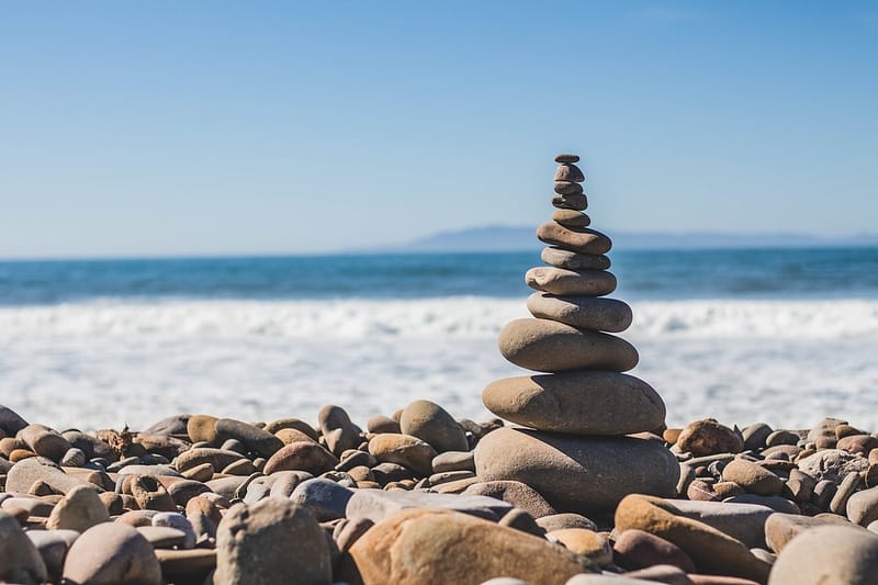 A pile of rocks sitting on top of a beach.
